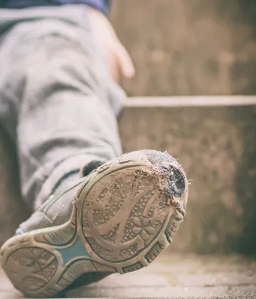 Child poverty worn out shoes