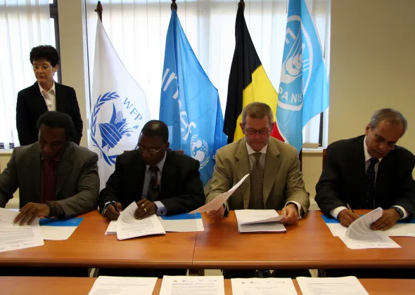 Photographs from an official ceremony in which representatives of the Government of Belgium, UNICEF, WFP and FAO signed a tripartite Memorandum of Understanding to implement a three-year joint programme to respond to the household food security needs of the most vulnerable populations of Abim, Kaberamaido and Kotido Districts in north-eastern Uganda.|A total of US$1.6 million has been committed by Belgium, through the Belgian Survival Fund, to focus on the household and community levels to address household