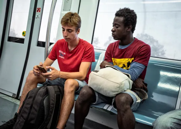 Ibrahim Kondeh takes the train with his foster brother Andrea on August 27, 2019.  Ibrahim was born Eastern Sierra Leone to a family who did subsistence farming. At 6 years old, Ibrahim moved to Freetown to attend school, where he lived with his aunt. In 2014, his father passed away and in 2016, after visiting his mother at home and experiencing what he described as a difficult and unsafe situation in his community, he decided that he needed to leave Sierra Leone.