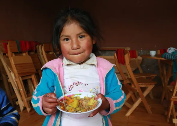 In 2019, a girl eats lunch in the Hanaq Chuquibamba community in Peru.