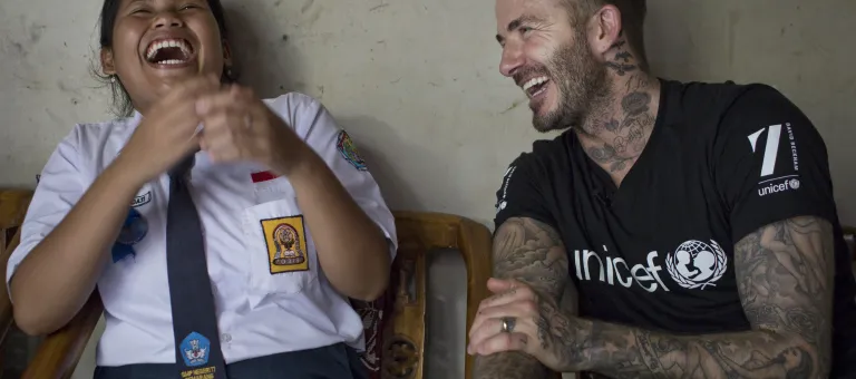 UNICEF Goodwill Ambassador David Beckham smiles with Sripun, 15, at her home in Semarang, Indonesia, March 27, 2018. 