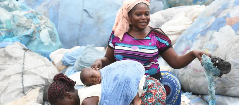 Woman are sorting plastic on a waste field in Abidjan, the capital of Côte d'Ivoire.