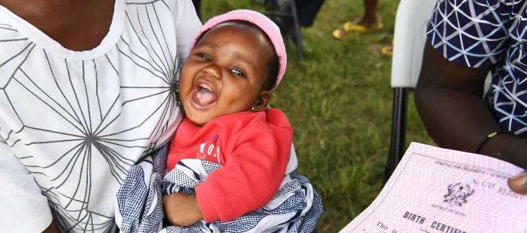 Elorm, 2 months old, seems to be very happy with her birth registration, in Accra, the capital of Ghana.