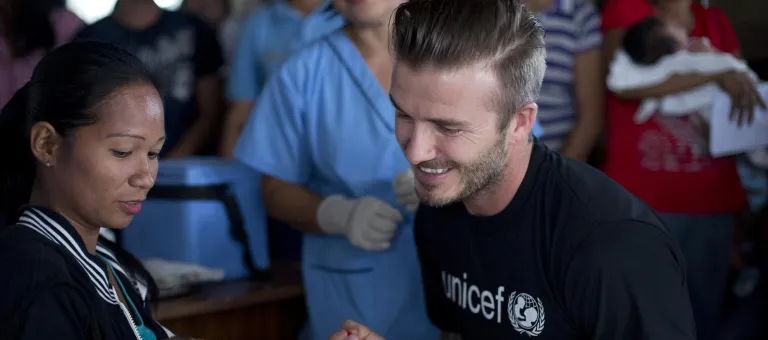 UNICEF Goodwill Ambassador David Beckham gives a child a polio vaccine at a UNICEF-supported health centre.