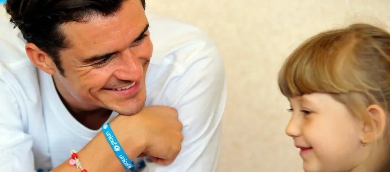 On 27 April 2016, (left) UNICEF Goodwill Ambassador Orlando Bloom plays lego with pupils of School #13 in Slovyansk, as part of a visit to conflict-hit eastern Ukraine. He was in the country to raise awareness of the global education crisis facing children in emergencies.
