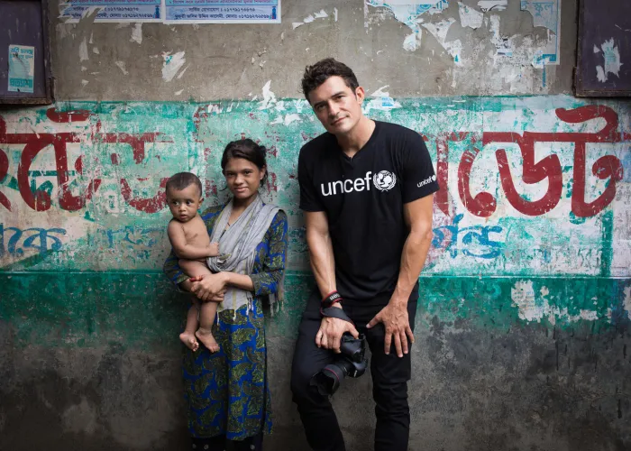 On 29 July 2018 in Bangladesh, UNICEF Goodwill Ambassador Orlando Bloom on location in Bangladesh filming for "Tales by light" seen with a 14 year old mother with her one year old child